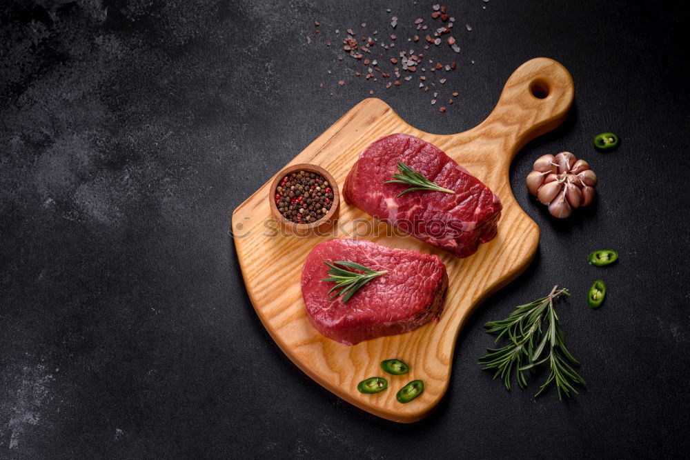 Similar – Image, Stock Photo Steaks with ingredients on a round chopping board