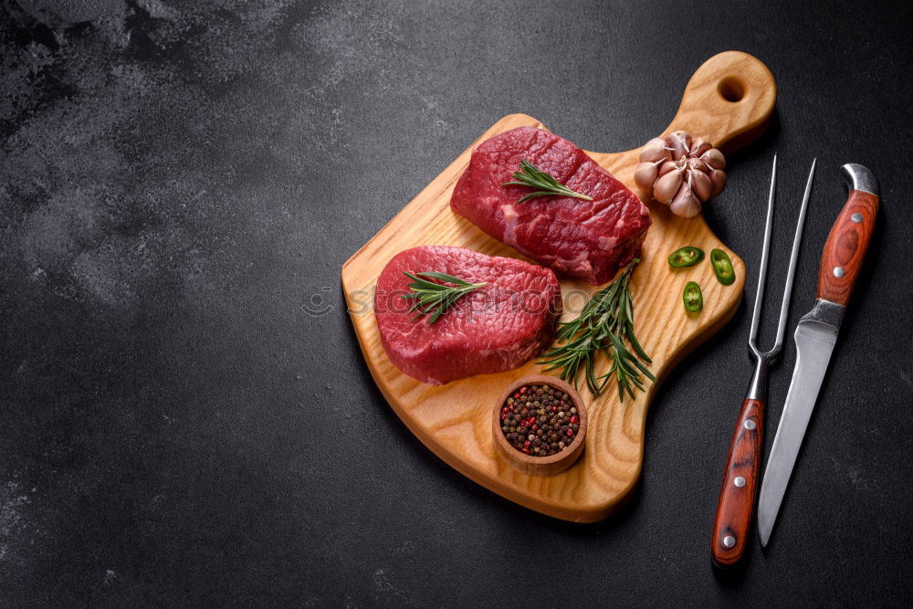 Similar – Image, Stock Photo Steaks with ingredients on a round chopping board