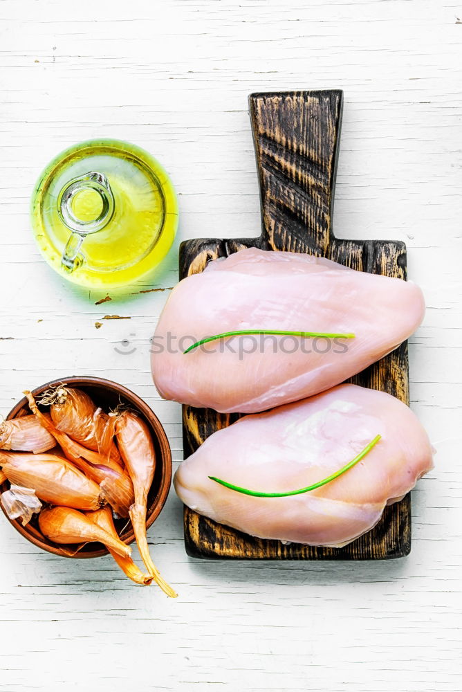 Similar – Raw prawn or shrimps and squids on light blue background, decorated with with seaweeds and lemon, top view, flat lay. Seafood cooking concept