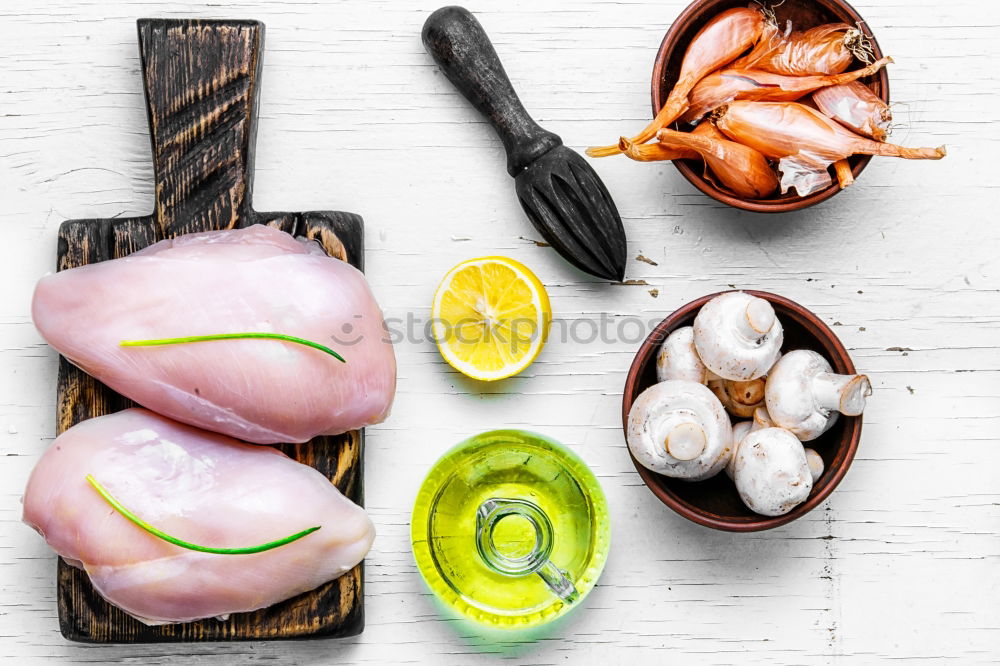 Similar – Raw prawn or shrimps and squids on light blue background, decorated with with seaweeds and lemon, top view, flat lay. Seafood cooking concept