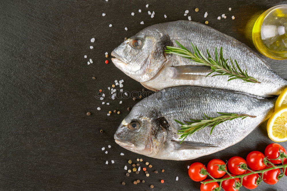 Similar – Image, Stock Photo Two Dorado fish with cooking ingredients