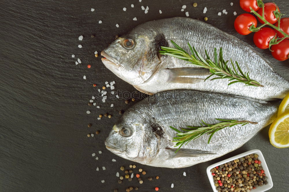 Similar – Image, Stock Photo Two Dorado fish with cooking ingredients