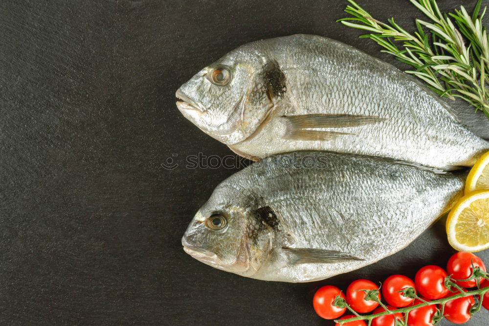 Similar – Image, Stock Photo Two Dorado fish with cooking ingredients