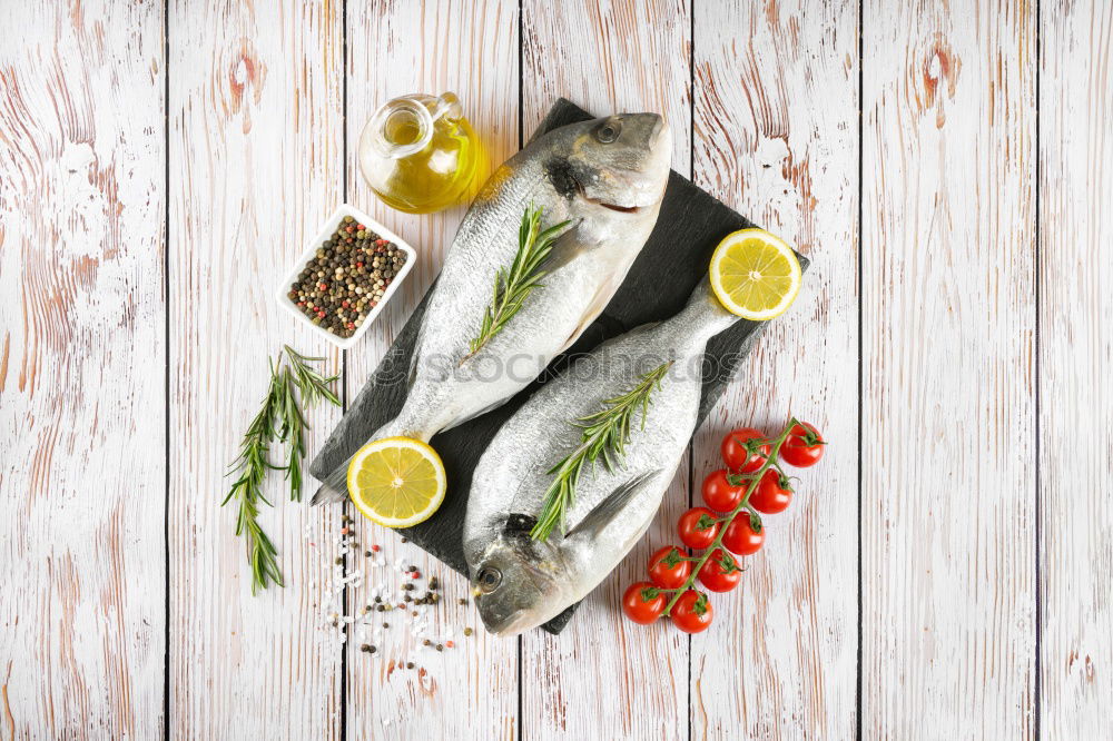 Similar – Raw prawn or shrimps and squids on light blue background, decorated with with seaweeds and lemon, top view, flat lay. Seafood cooking concept