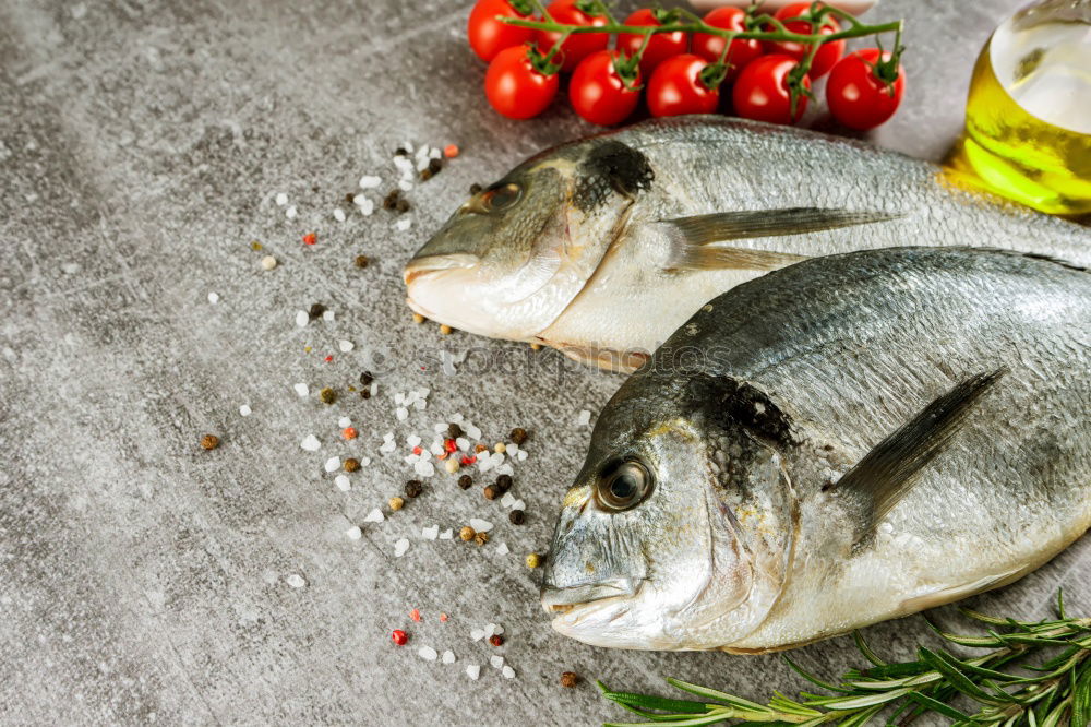 Similar – Image, Stock Photo Two Dorado fish with cooking ingredients