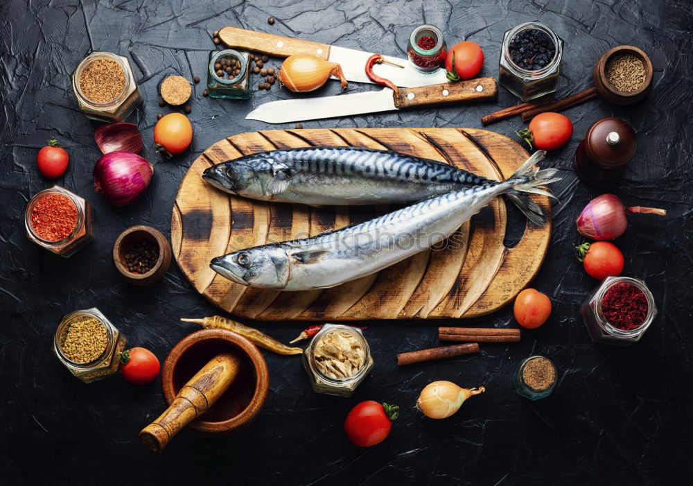 Similar – Raw fish on white paper with ingredients for cooking