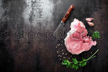 Similar – Juicy pieces of meat with spices and butcher’s knife