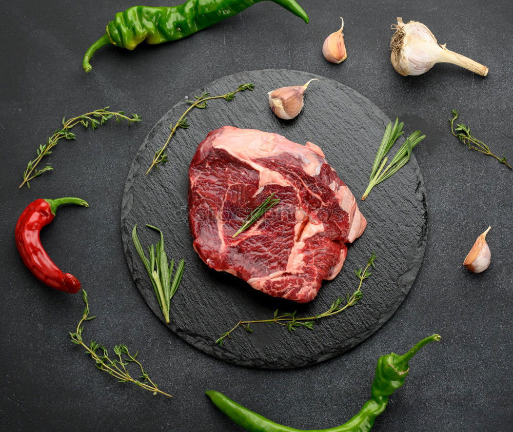 Image, Stock Photo Steaks with ingredients on a round chopping board