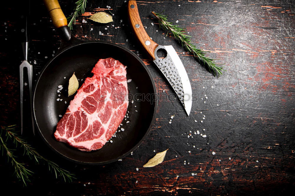 Similar – Juicy pieces of meat with spices and butcher’s knife