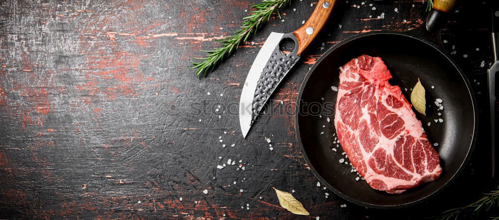 Juicy pieces of meat with spices and butcher’s knife