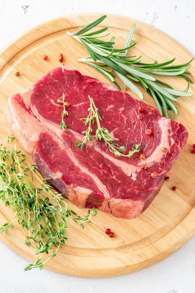 Similar – Image, Stock Photo Prepare steaks with herbs and butter