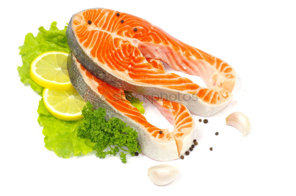 Similar – Raw salmon fillet with green herbs and lemon