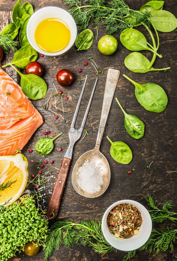 Fish with fresh ingredients, spoon and fork