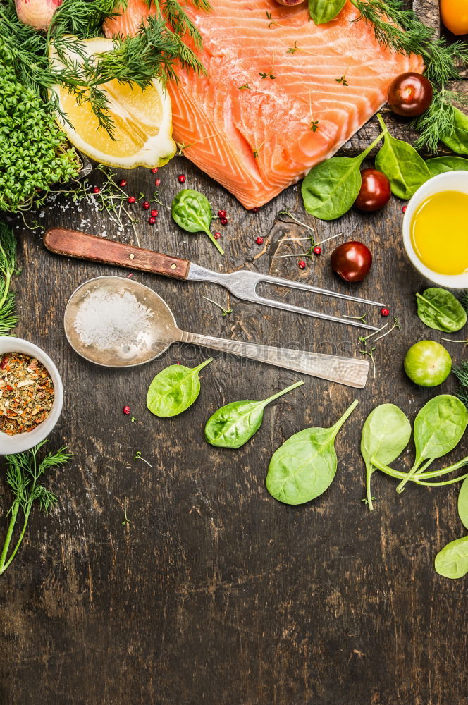 Salmon fillet with ingredients on a rustic wooden table