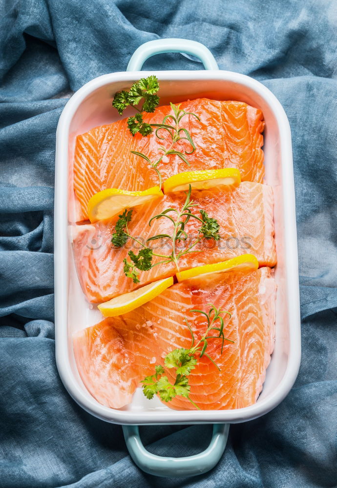 Salmon fish fillet with lemon in bowl