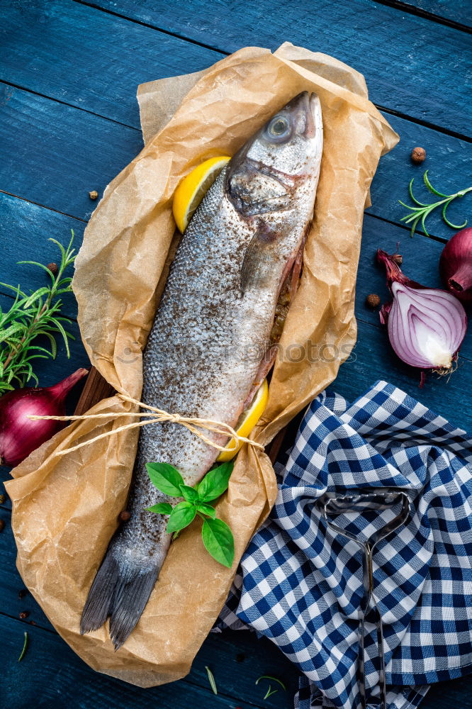 Similar – Image, Stock Photo Preparing whole salmon fish for cooking.