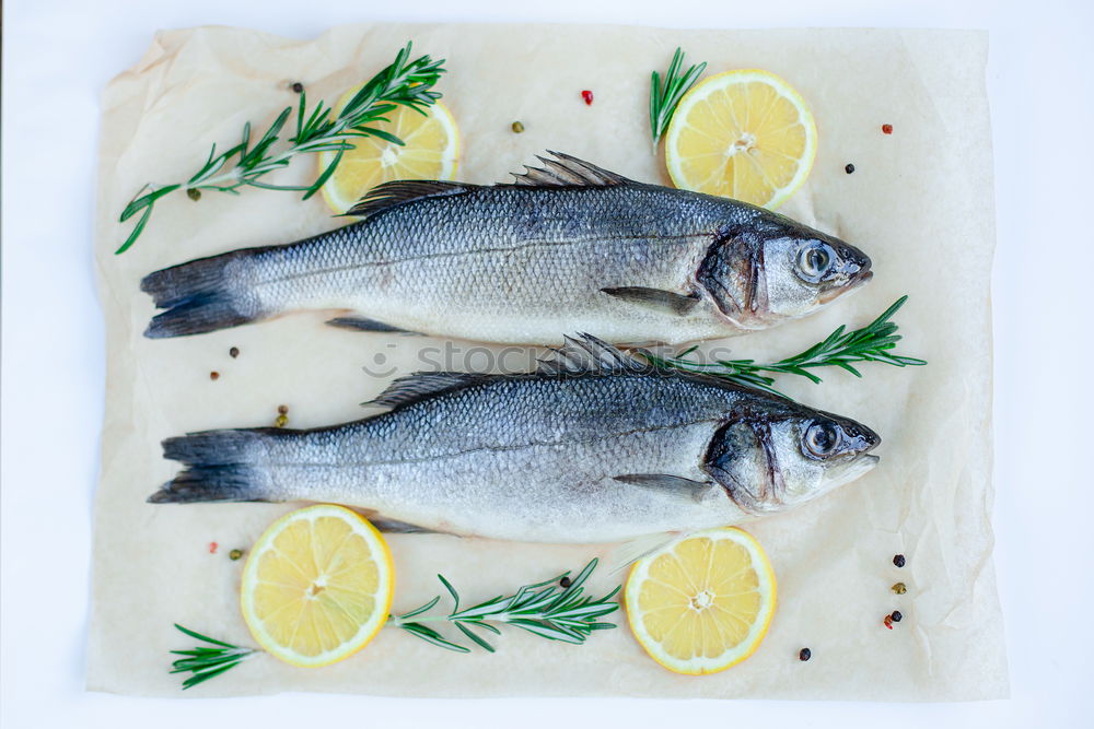 Similar – Image, Stock Photo Sea bass on kitchen table with lemon and rosemary