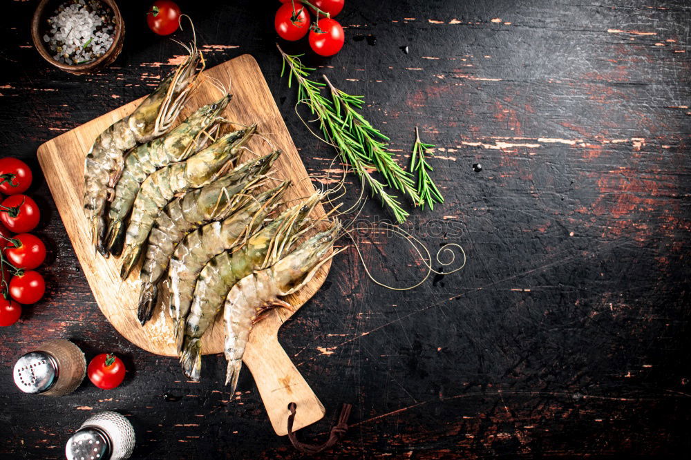 Similar – Image, Stock Photo Grilled sardines on baking tray with ingredients: lemon, garlic and herbs for tasty seafood eating. Cooking preparation of fishes