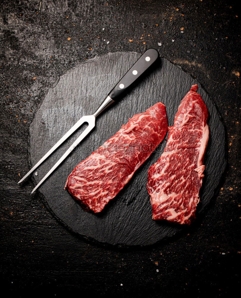 Similar – Image, Stock Photo T-bone steak on grill pan with meat fork, oil and spices