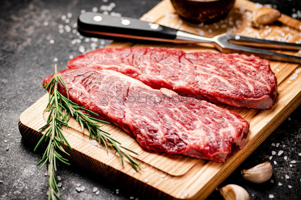 Similar – Image, Stock Photo Prepare steaks with herbs and butter