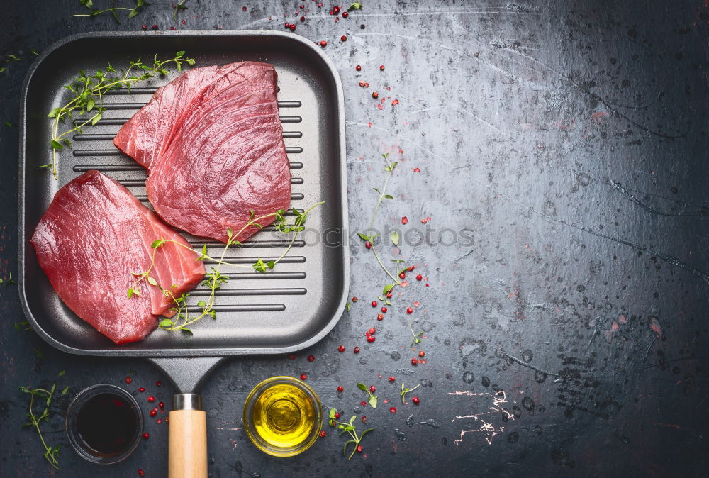 Grill steak ingredients around empty table.