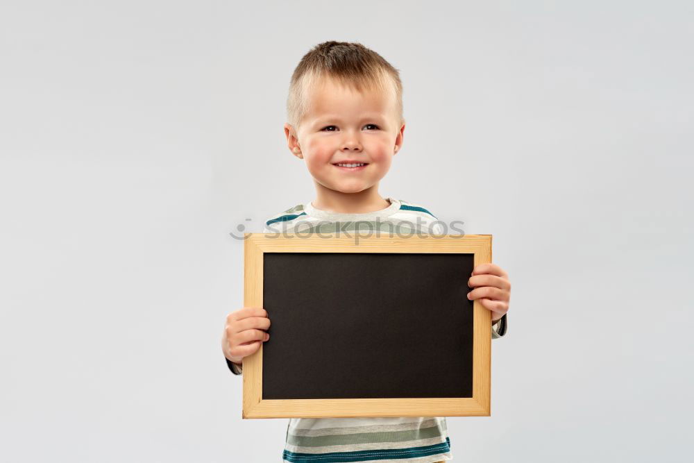 Similar – Image, Stock Photo smiling child holding a blackboard