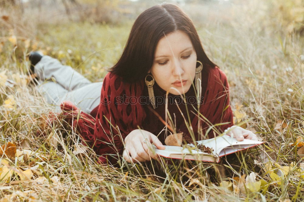 Similar – Woman reading a book outdoors