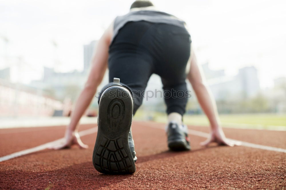 Similar – Image, Stock Photo Close-up shot of man tying running shoes with foot on the bench. Getting ready before jogging. Going in for sports, healthy lifestyle