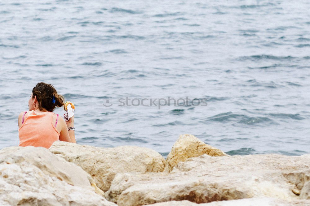 Image, Stock Photo Woman sitting at edge of rock