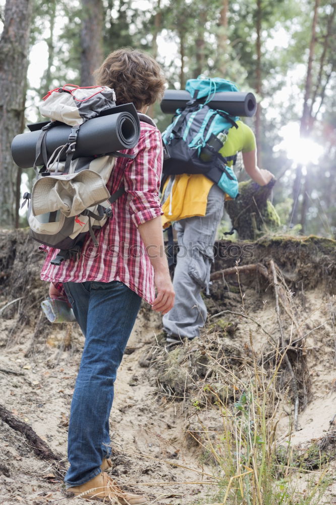 Similar – Hiker closing his partner’s backpack