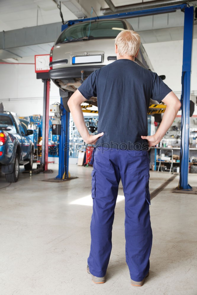 Similar – Professional Mechanic Repairing Car.