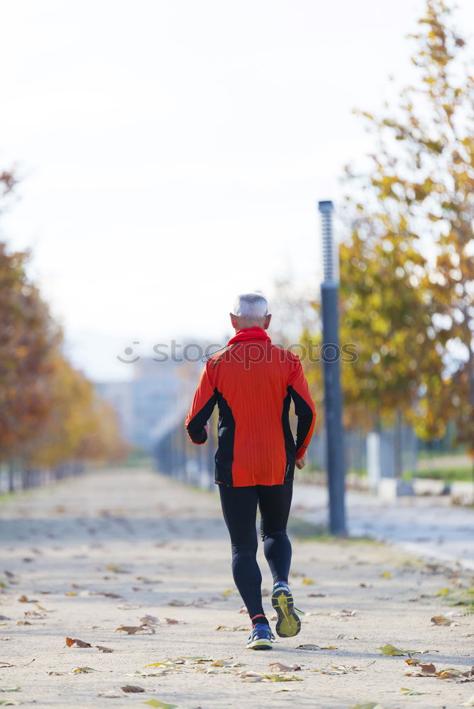 Similar – Image, Stock Photo Rear view of a senior man in sport clothes jogging in the park