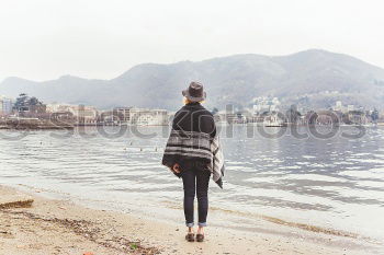 Young dreamy woman at seaside