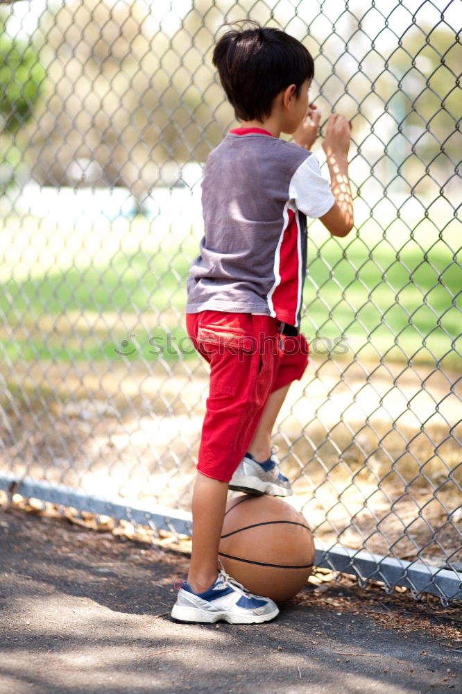 Similar – Teenage playing basketball on an outdoors court