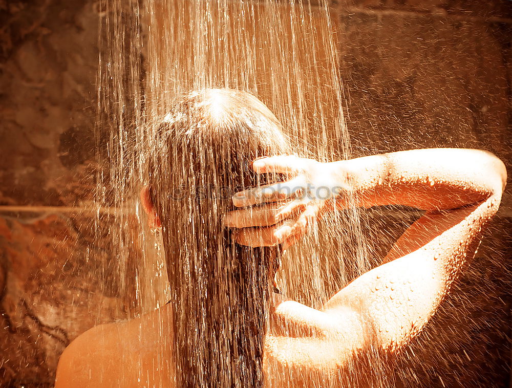 Man taking shower in wooden bathroom