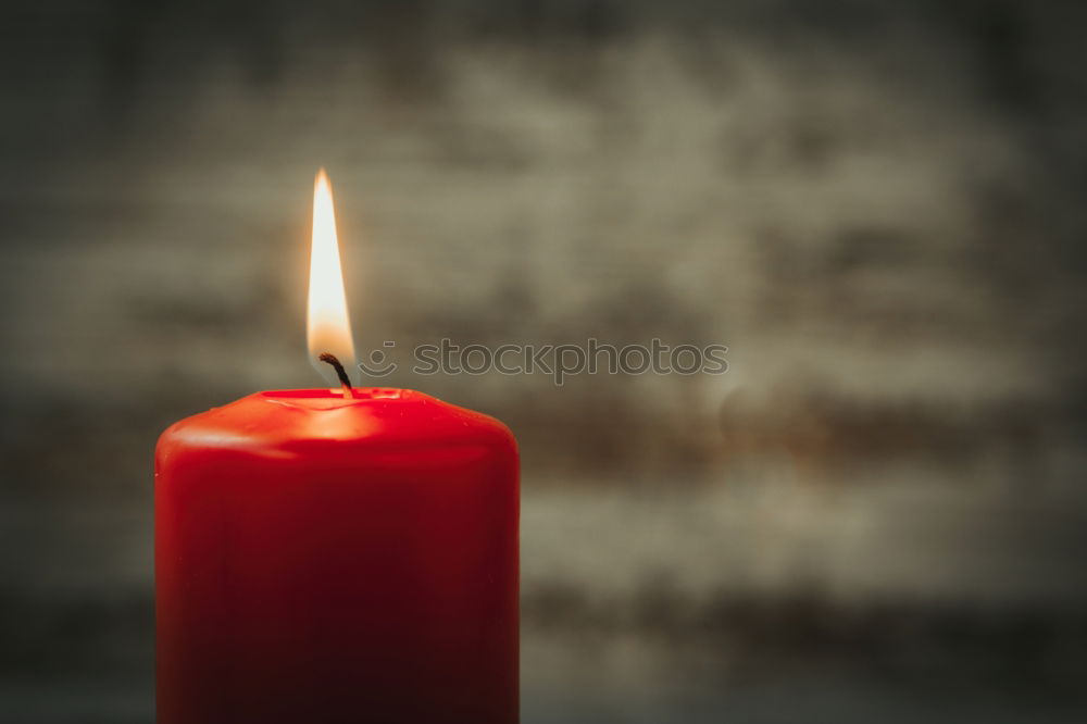 Similar – A single red burning candle held by a girl