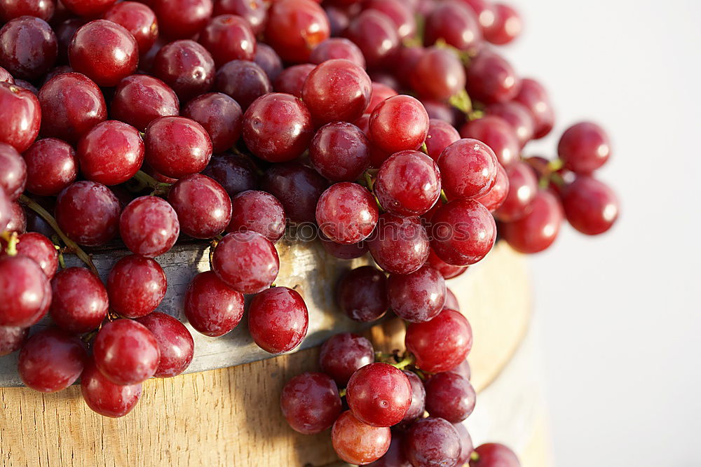 Similar – Image, Stock Photo Red grapes on an old wooden table close up