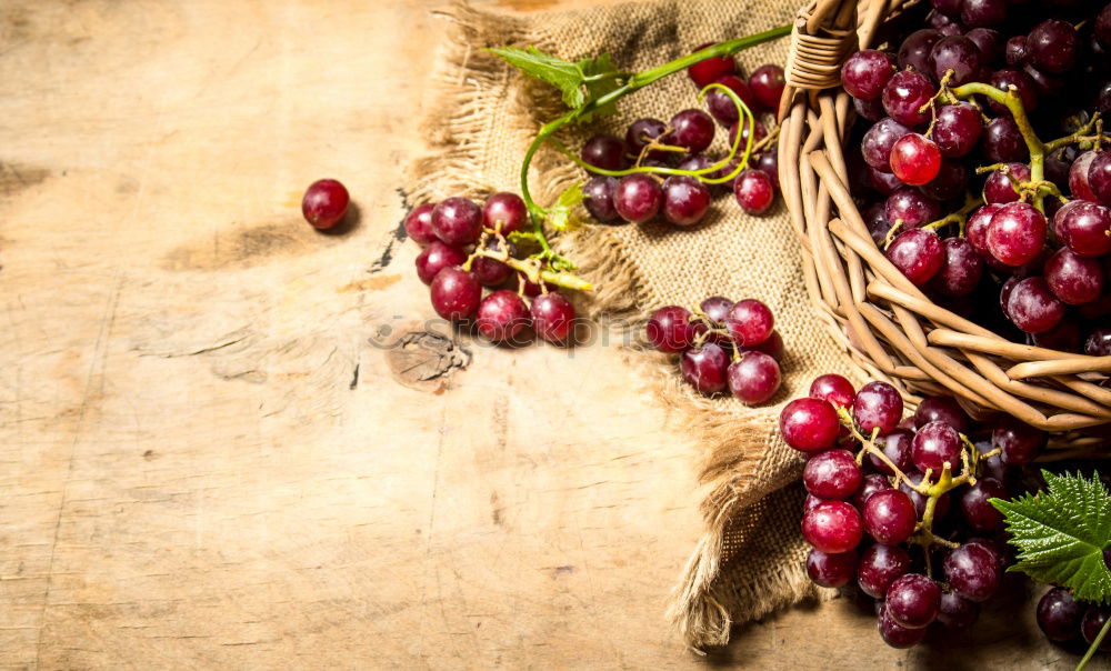 Similar – Image, Stock Photo Red grapes on an old wooden table close up