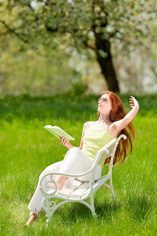 Similar – Jule Young woman with dreads is sitting on a bench in the green.