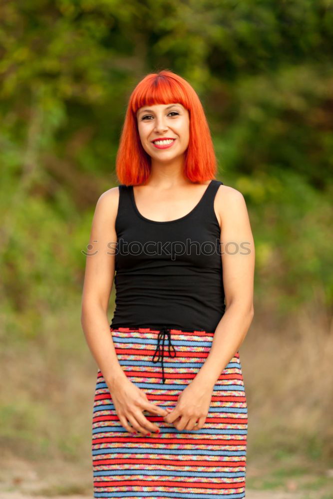 Similar – Redhead woman smelling a flower in a park