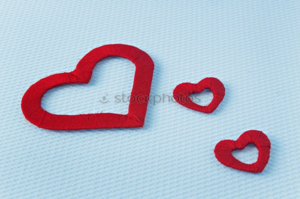 Image, Stock Photo Three stitched toy hearts, pink, red and teal on blue felt