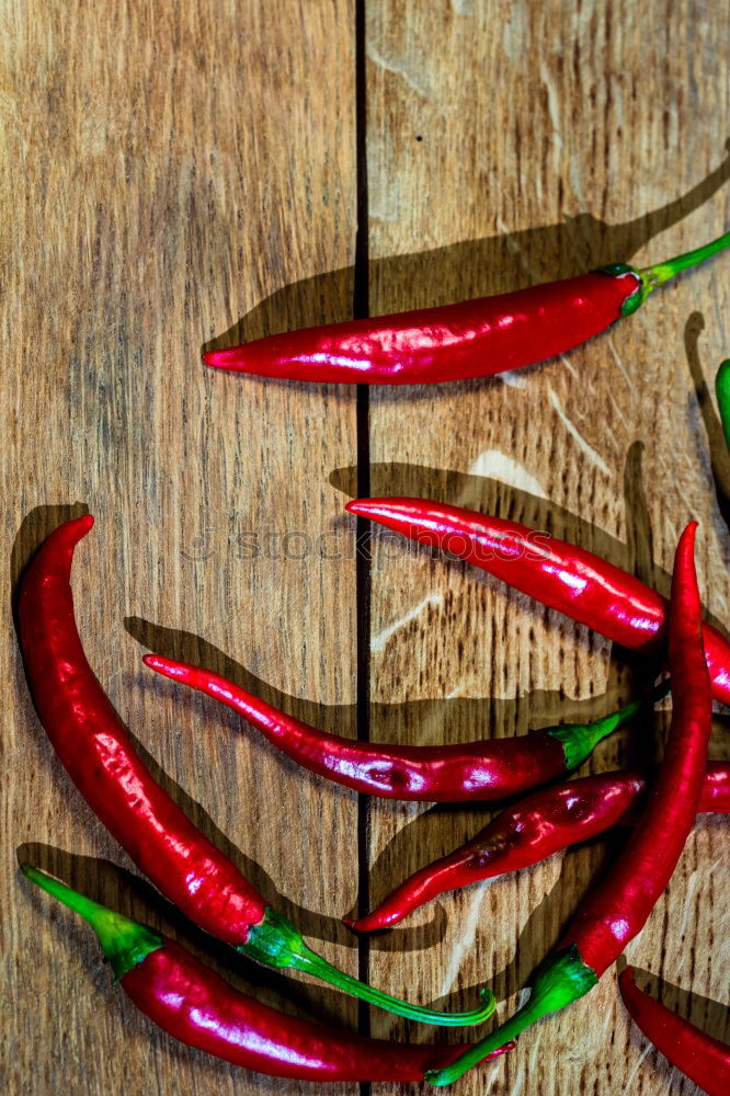 Similar – Image, Stock Photo Red hot chili peppers on a wooden background