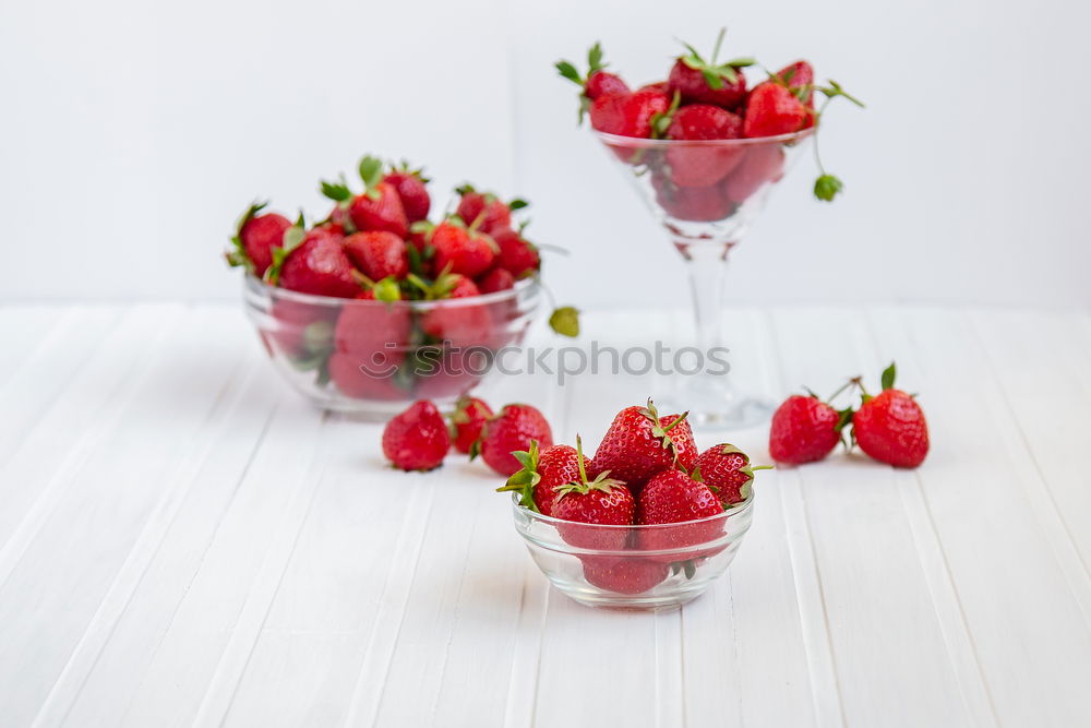 Similar – Pink sweet lemonade made of raspberry juice with frosted blackberries and strawberry blossom in a glass with sugar rim and drinking straw on striped tablecloth