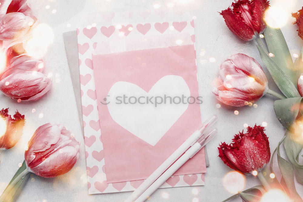 Table with cup of coffee, gift and pink tulips