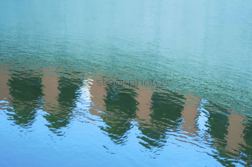 Similar – Rainwater on a blue garden table with reflection