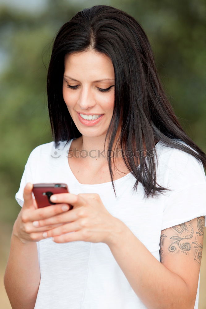 Similar – Young woman texting with a smartphone outdoors