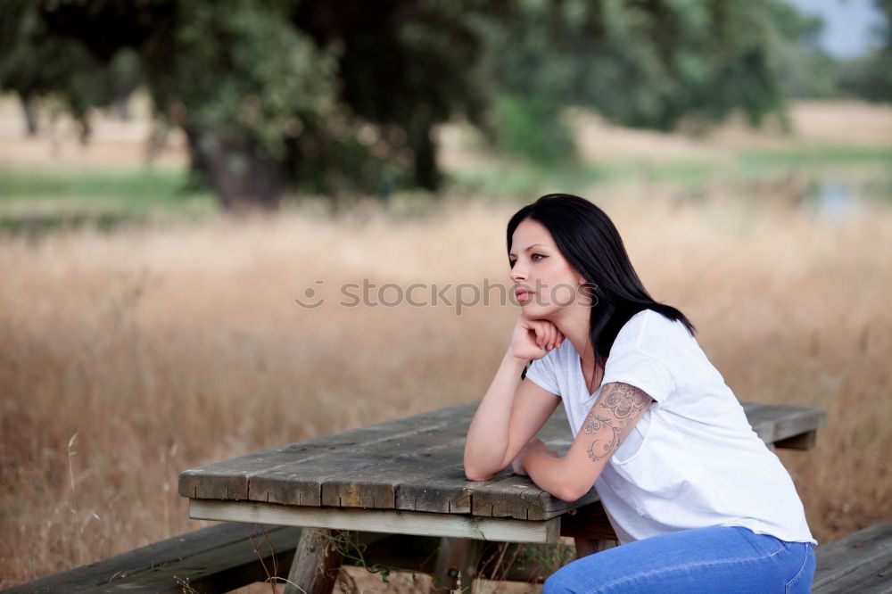 Similar – A young woman sitting on a garden bench