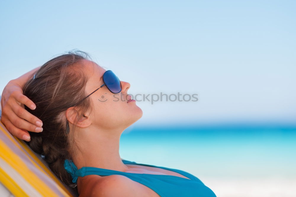 Similar – Woman in bikini sitting on bench near water