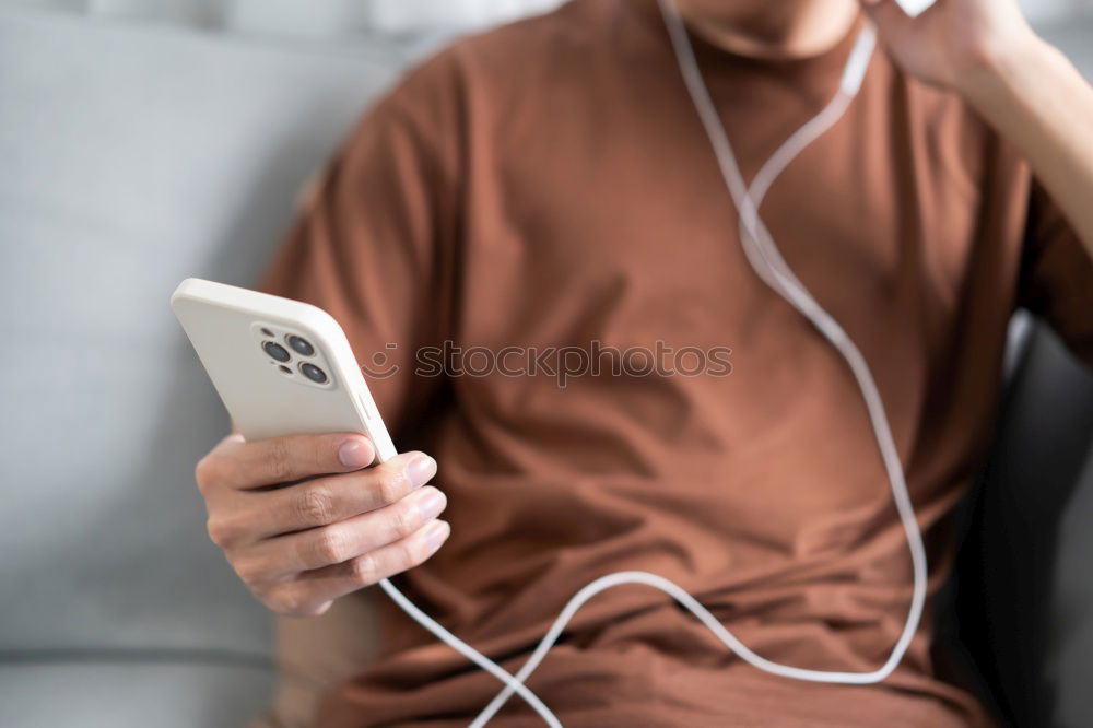 Similar – Image, Stock Photo Young man waiting listening music and using mobile phone at the airport with a suitcase.