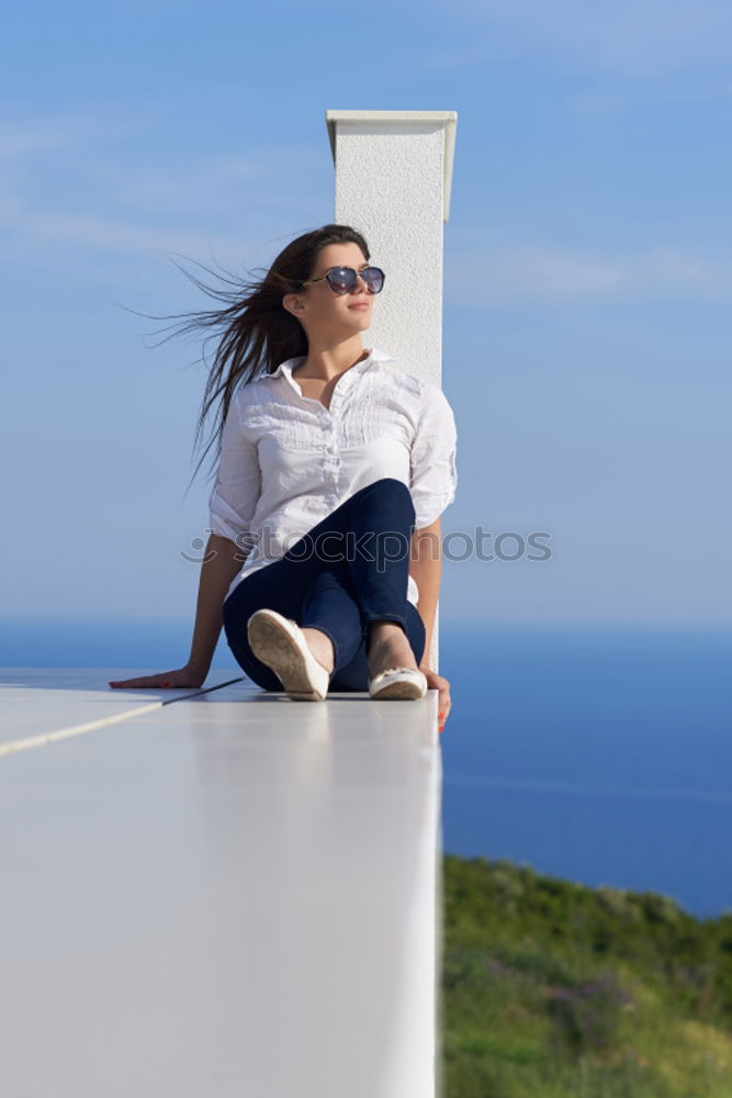 Similar – Woman barefoot sitting on roof of car